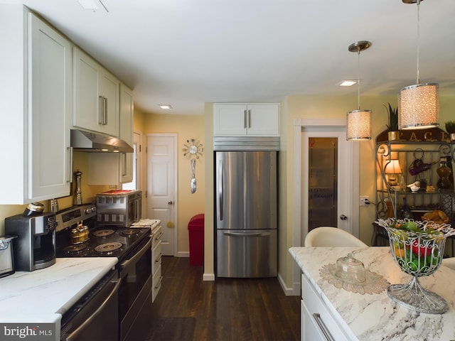 kitchen featuring appliances with stainless steel finishes, hanging light fixtures, light stone counters, exhaust hood, and dark hardwood / wood-style floors