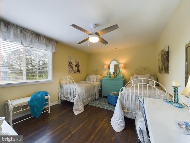 bedroom with dark wood-type flooring and ceiling fan