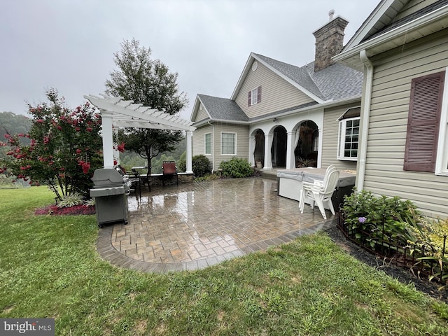 exterior space featuring a patio, a pergola, and a lawn