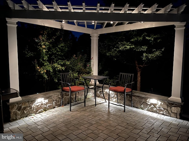 patio at twilight featuring a pergola