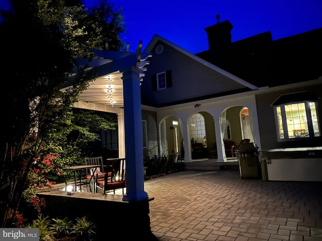 back house at night with a patio area