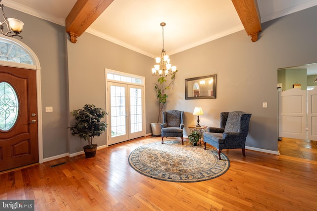 foyer featuring crown molding, hardwood / wood-style floors, beamed ceiling, and a chandelier