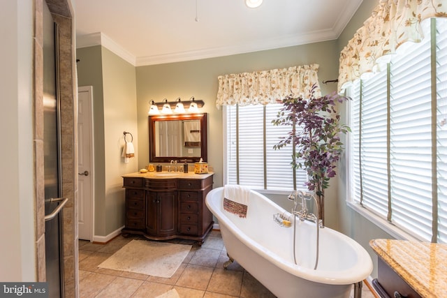 bathroom with a wealth of natural light, tile patterned floors, a tub, and vanity