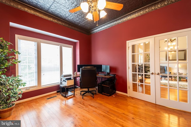 home office with plenty of natural light, crown molding, and light hardwood / wood-style floors