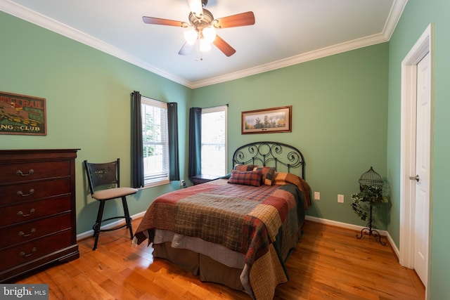 bedroom with ceiling fan, light hardwood / wood-style floors, and ornamental molding