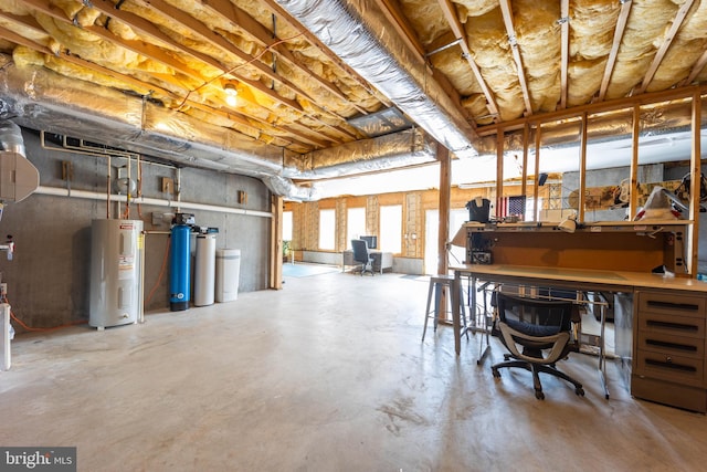 basement featuring a workshop area and water heater