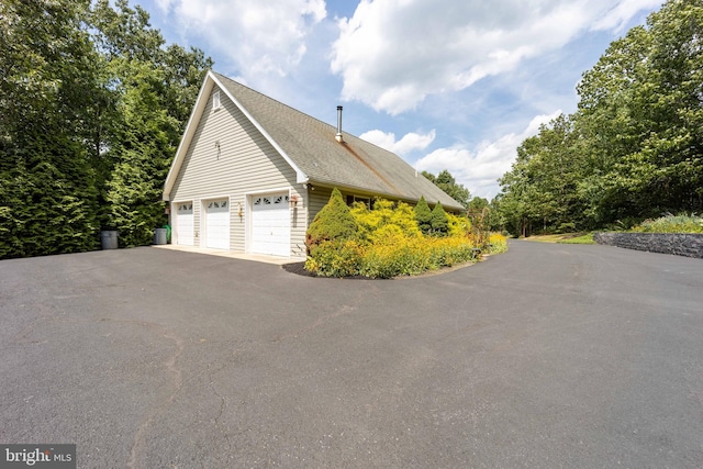 view of side of home with a garage