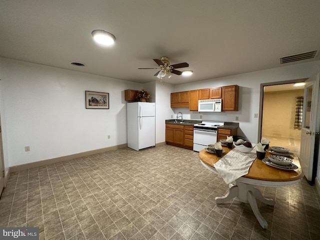 kitchen featuring ceiling fan, sink, white appliances, and light tile patterned floors