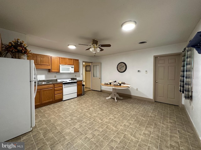 kitchen with light tile patterned flooring, sink, ceiling fan, and white appliances