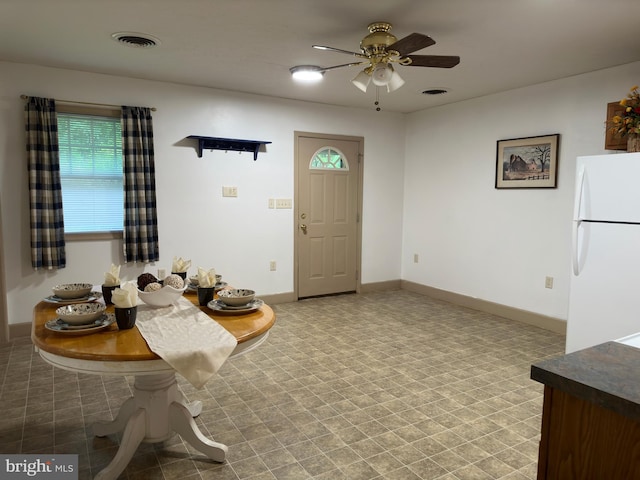 tiled dining area with ceiling fan and a healthy amount of sunlight