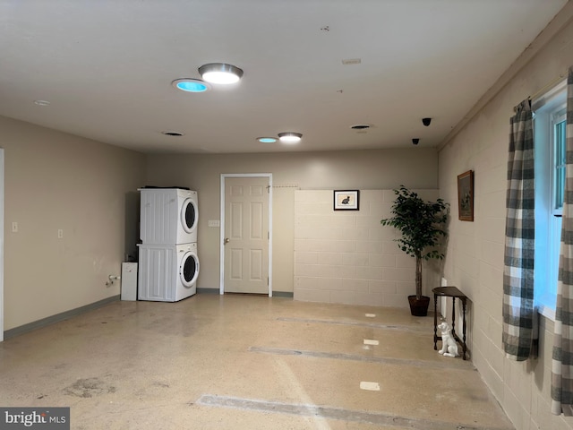 interior space featuring stacked washing maching and dryer