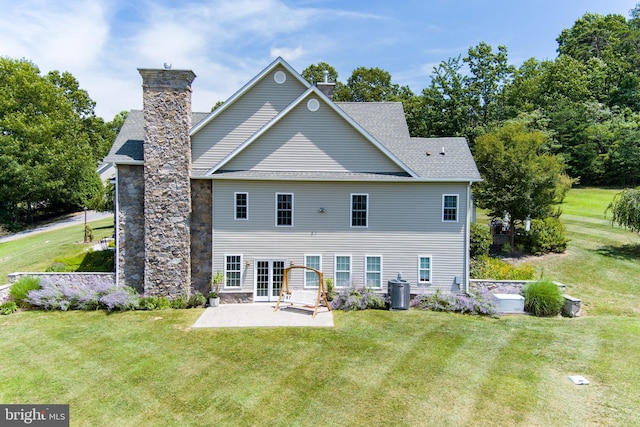 back of house featuring a lawn and a patio area