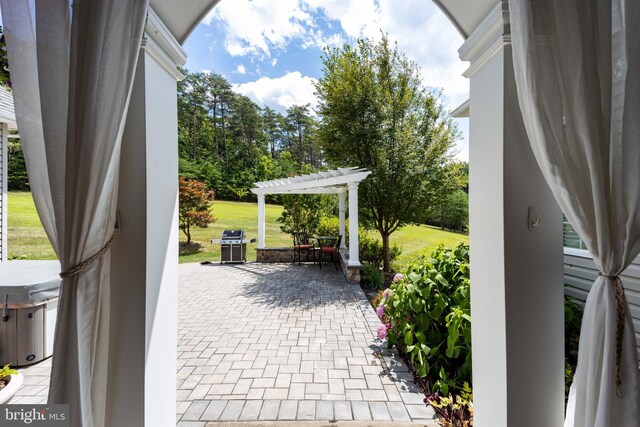 view of patio / terrace with a pergola and area for grilling