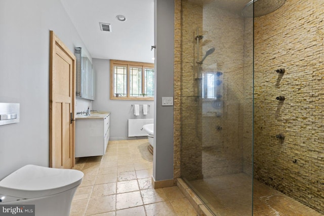 bathroom featuring a shower with shower door, vanity, tile patterned floors, and toilet