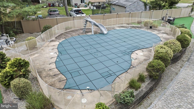 view of swimming pool with a water slide