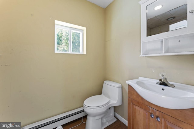 bathroom featuring vanity, toilet, baseboard heating, and wood-type flooring