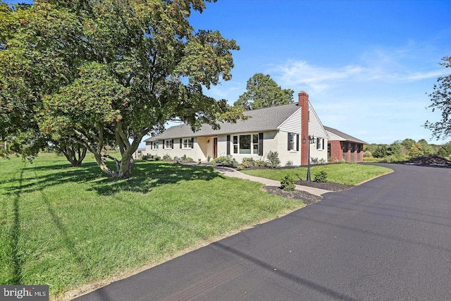 ranch-style house with a front lawn