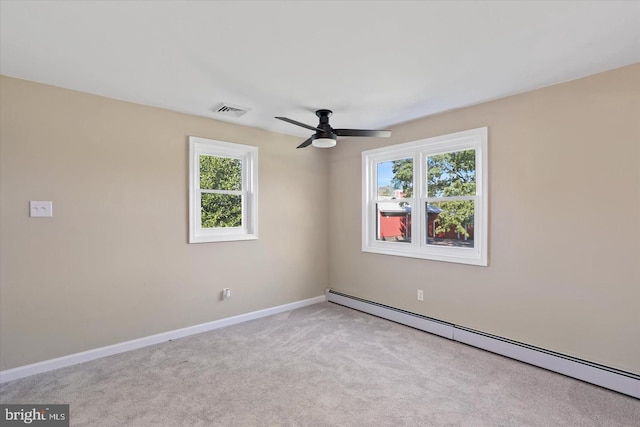 carpeted empty room featuring ceiling fan and baseboard heating