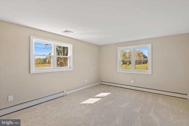 carpeted empty room featuring a baseboard radiator