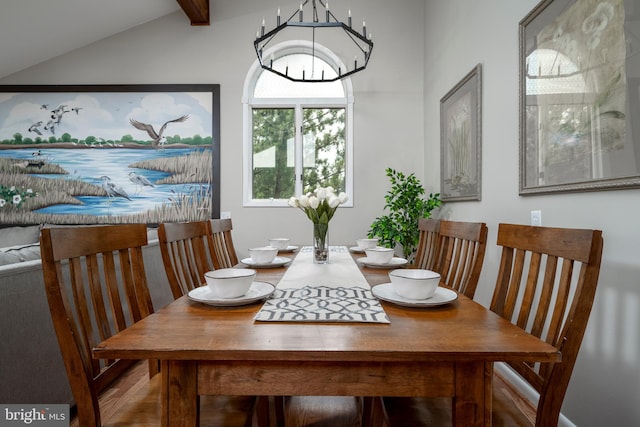 dining area featuring vaulted ceiling with beams