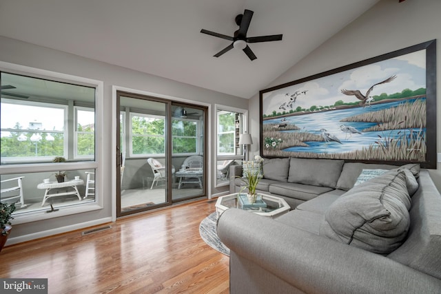 living room featuring lofted ceiling, hardwood / wood-style flooring, a healthy amount of sunlight, and ceiling fan