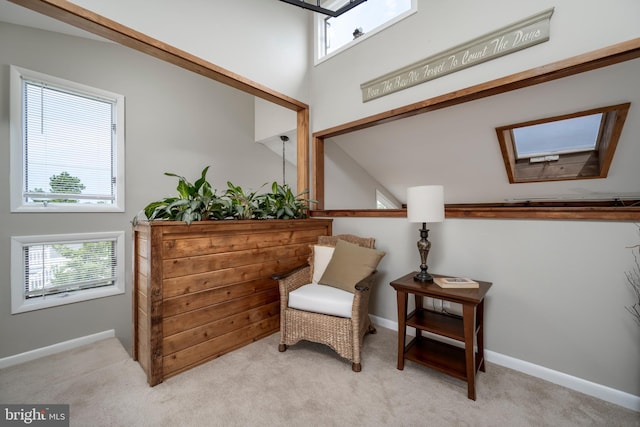 sitting room featuring light carpet and plenty of natural light