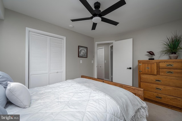 carpeted bedroom with a closet and ceiling fan