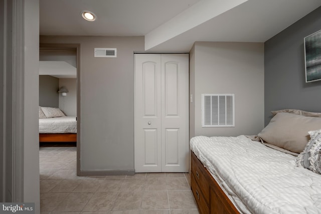 tiled bedroom with a closet