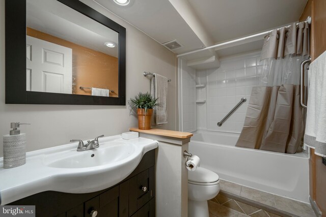 full bathroom with vanity, shower / tub combo with curtain, toilet, and tile patterned floors