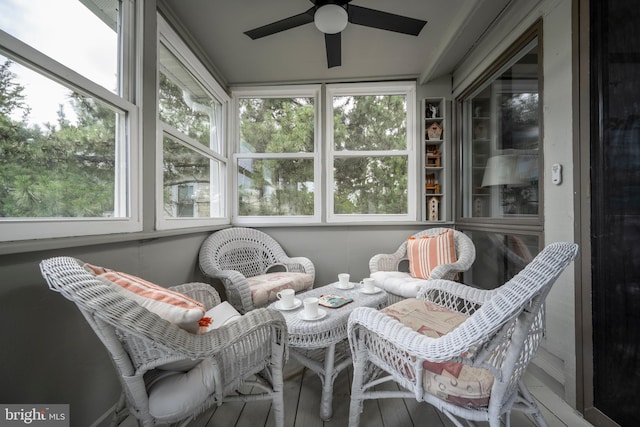 sunroom / solarium featuring ceiling fan