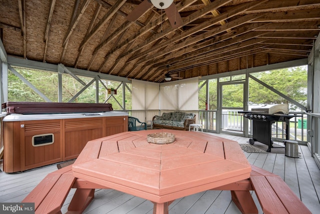 sunroom featuring vaulted ceiling and a jacuzzi