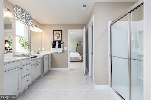 bathroom featuring tile patterned flooring, vanity, and walk in shower