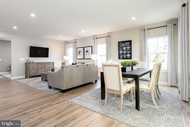 dining space with a healthy amount of sunlight and light hardwood / wood-style flooring