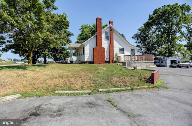 view of side of home with a lawn