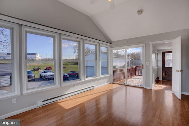 unfurnished sunroom with ceiling fan, a baseboard radiator, and lofted ceiling