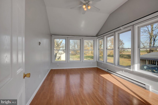 unfurnished sunroom featuring a baseboard radiator, ceiling fan, and vaulted ceiling