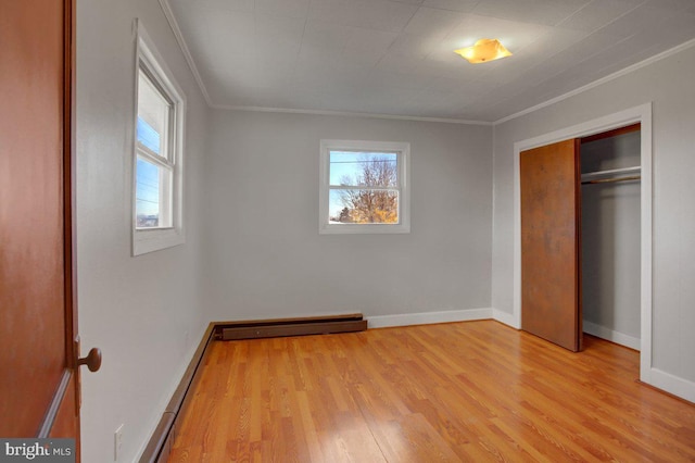 unfurnished bedroom with crown molding, a closet, and multiple windows