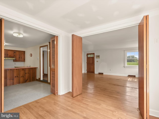 hallway with light wood-type flooring