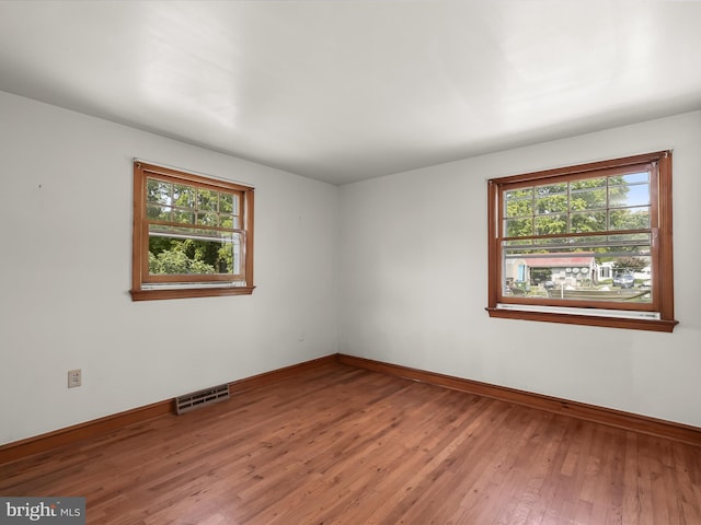 empty room with wood-type flooring