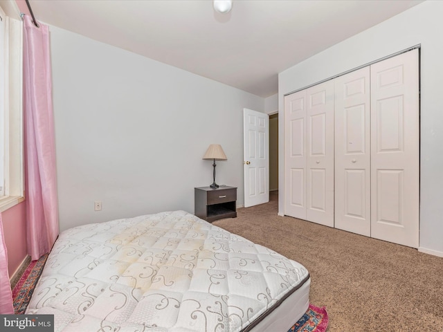 carpeted bedroom with a closet