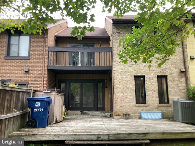 back of house featuring a balcony, a deck, and central AC