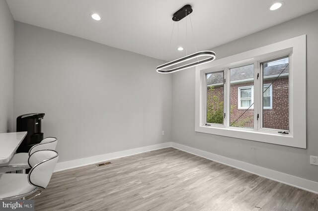 unfurnished dining area with light wood-type flooring