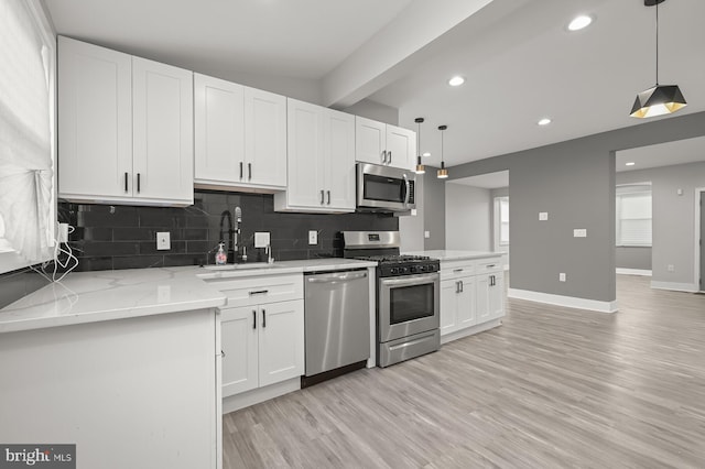 kitchen featuring white cabinetry, sink, and appliances with stainless steel finishes