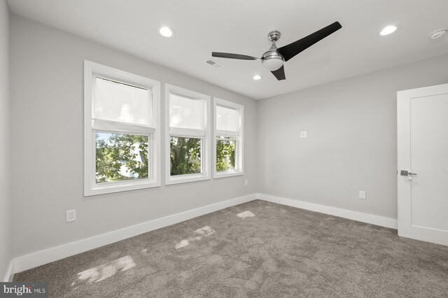 empty room featuring ceiling fan and carpet floors