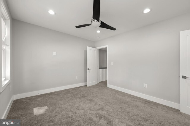 unfurnished bedroom featuring ceiling fan and carpet