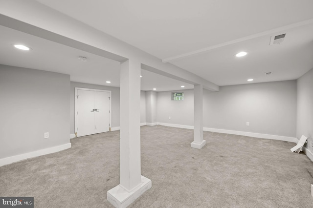 basement featuring light colored carpet