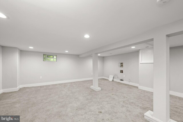 basement featuring light carpet