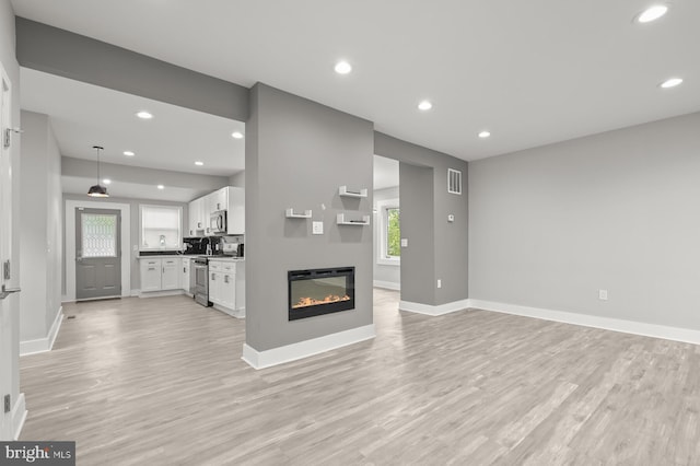 unfurnished living room featuring light hardwood / wood-style flooring