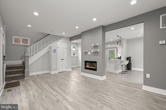 unfurnished living room featuring light hardwood / wood-style flooring