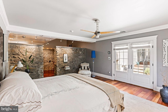 bedroom featuring french doors, access to outside, hardwood / wood-style flooring, and crown molding